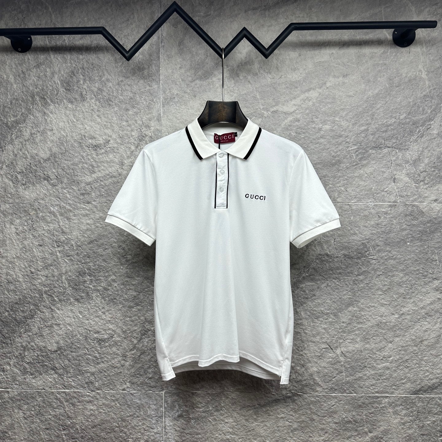 Gucci short-sleeve polo shirt, white with black-trim placket and chest logo.
