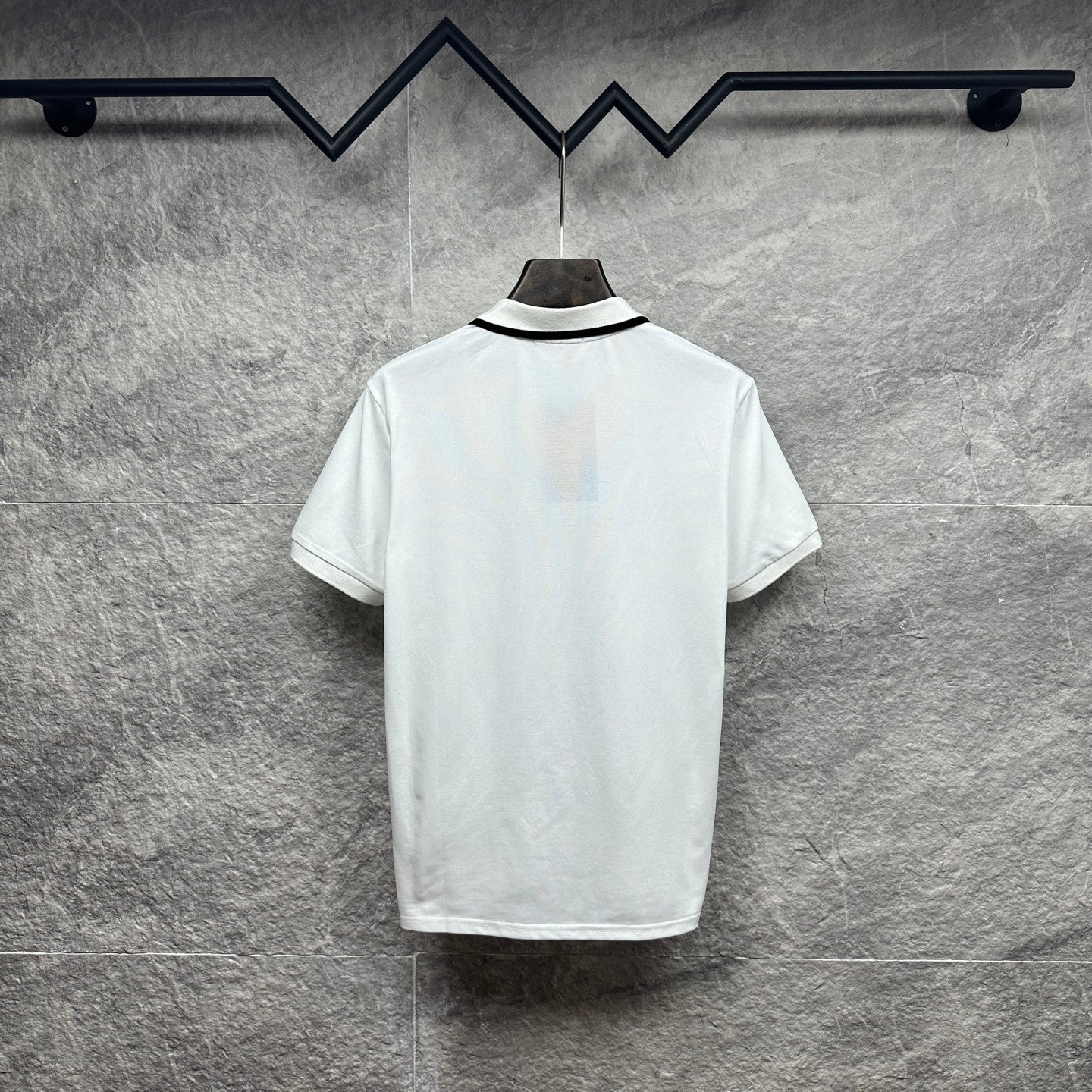 Gucci short-sleeve polo shirt, white back view with black-trim collar.