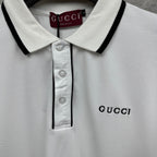 Gucci polo shirt collar detail, white with black trim and button placket.