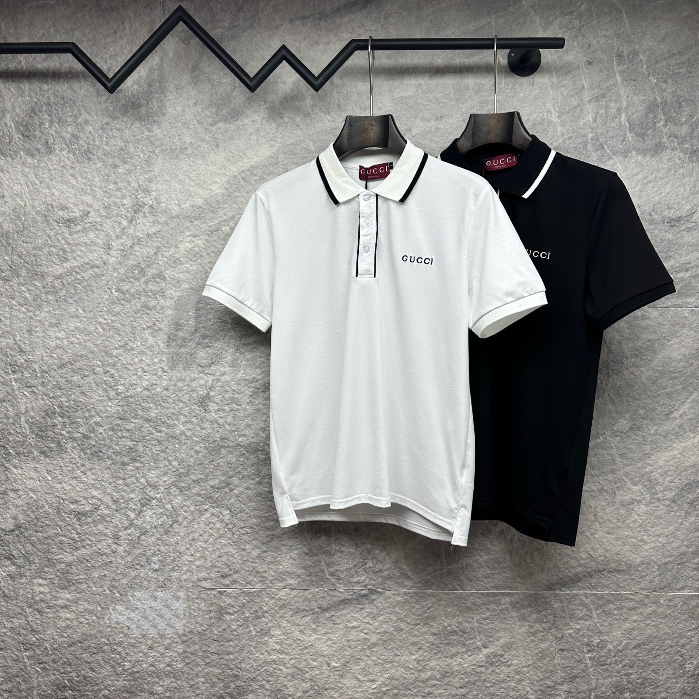 White and black polo shirts with white/black collar trim and Gucci branding
