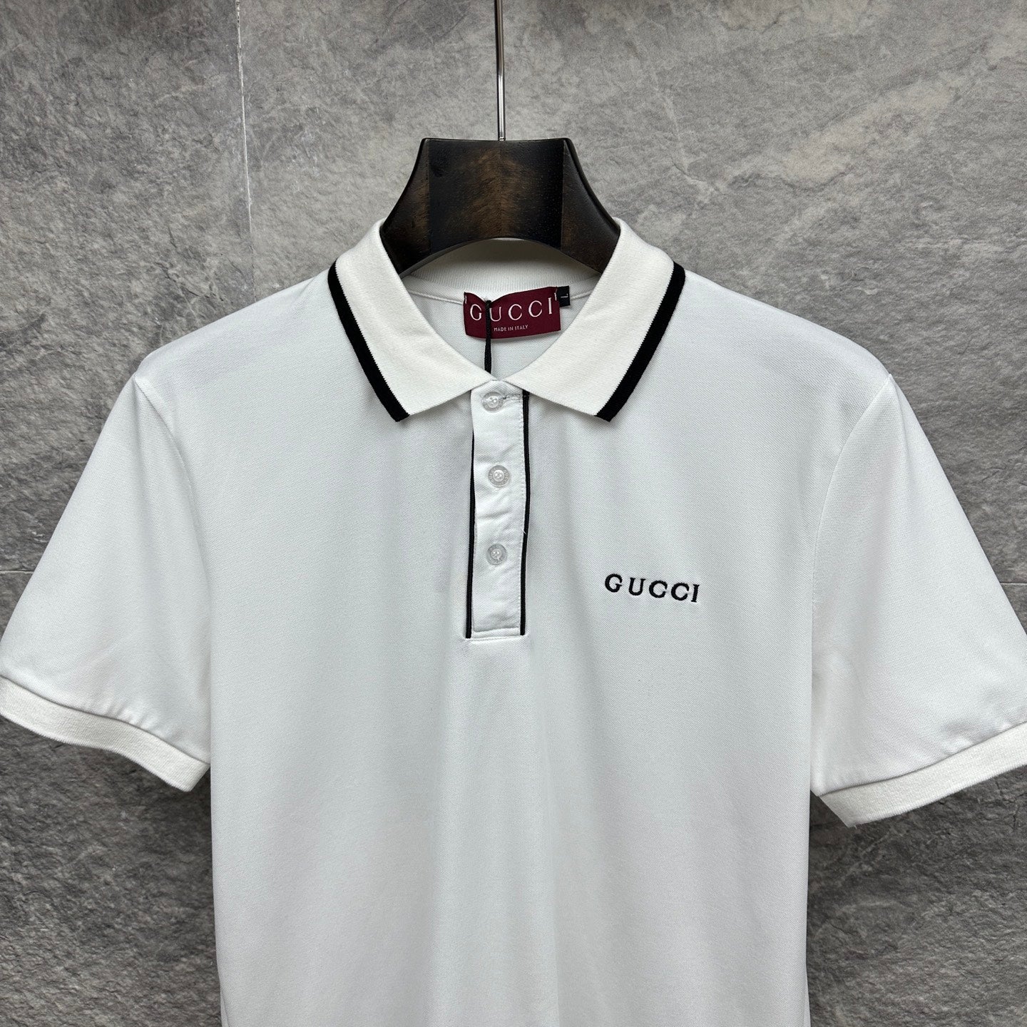 Gucci short-sleeve polo shirt, white front with black-trim collar and chest logo.