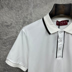 Gucci short-sleeve polo shirt neckline, white with black-trim collar and button placket.