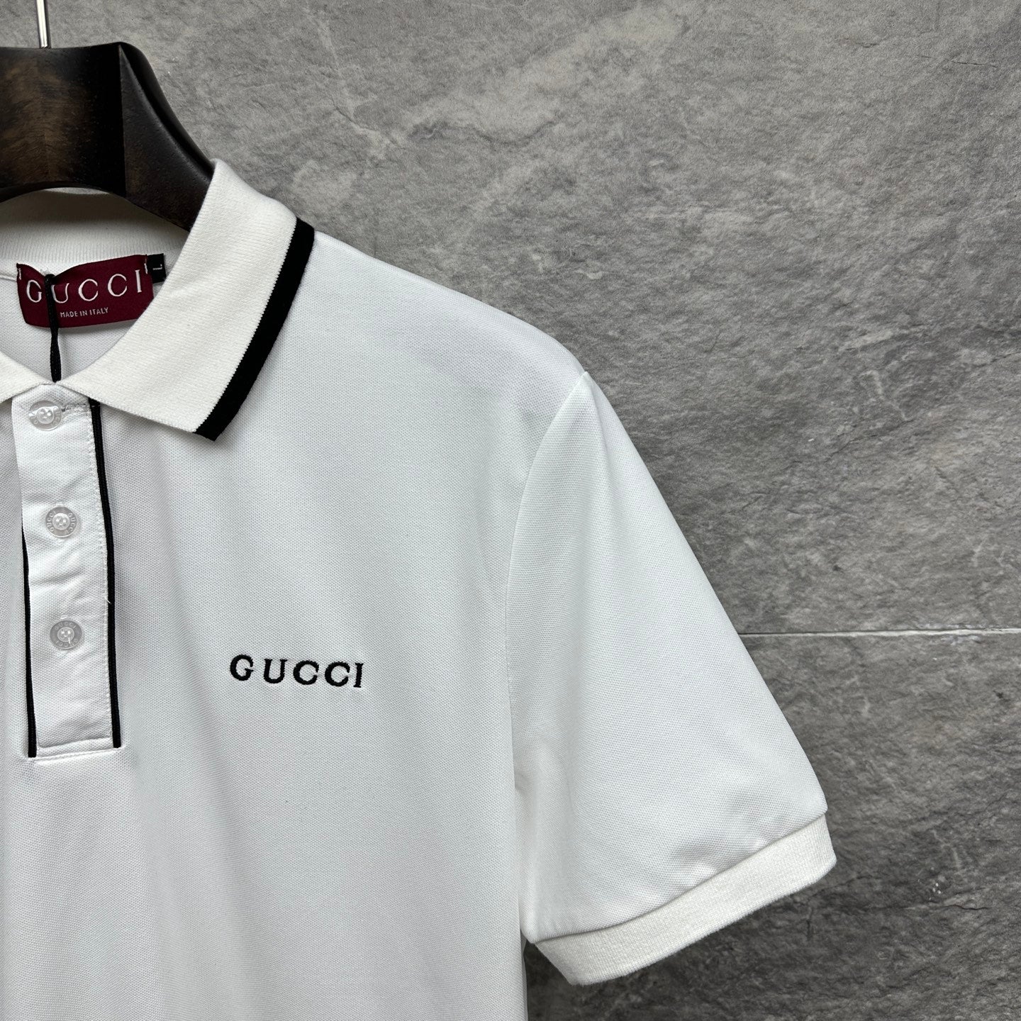 Gucci short-sleeve polo shirt, white with black-trim collar and small chest logo.