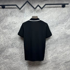 Black polo shirt with white-trim collar and short sleeves, back view