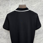 Black polo shirt back view with white collar trim