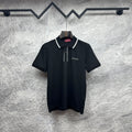 Black polo shirt with white collar trim, button placket, and Gucci logo