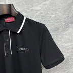 Black polo shirt chest with Gucci logo, white-trim collar, and short sleeves