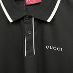 Black polo shirt button placket with white stripe and Gucci logo