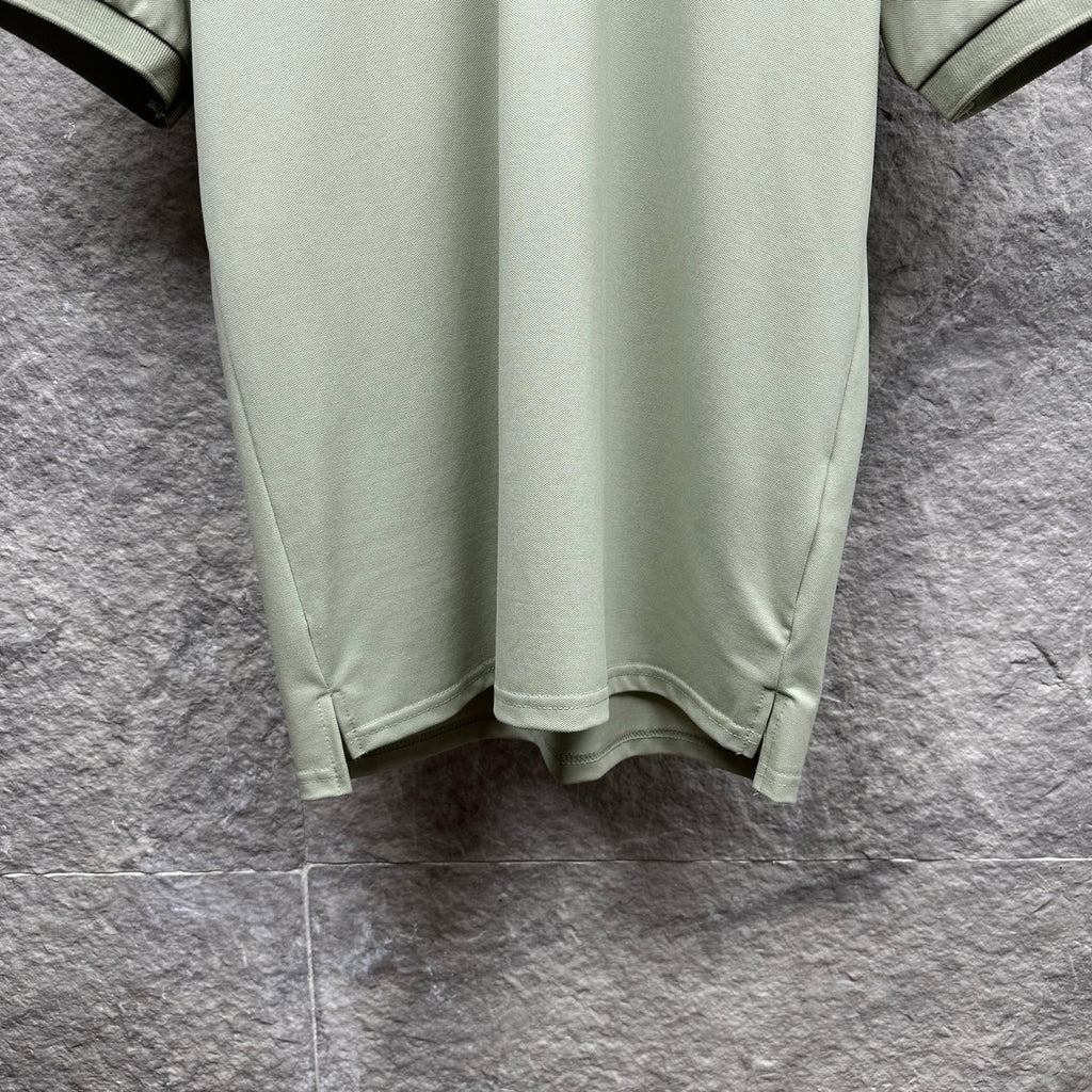 Mint green polo shirt hem with curved bottom and side seams
