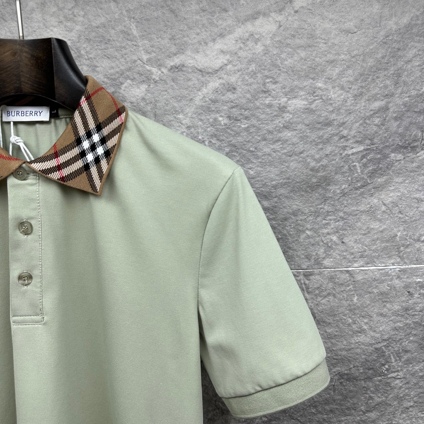 Mint green polo shirt sleeve with check collar edge and button placket