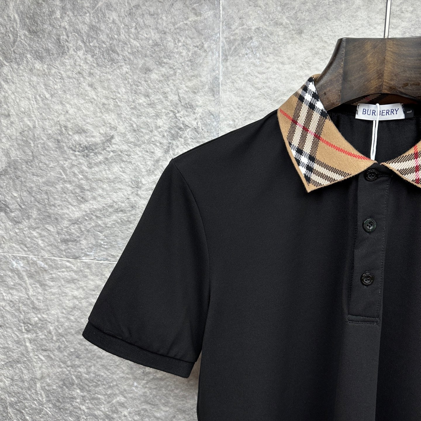 Burberry polo shirt close-up, black with tartan check collar and button placket