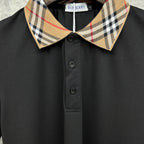 Burberry polo shirt close-up: tartan check collar and button front, black