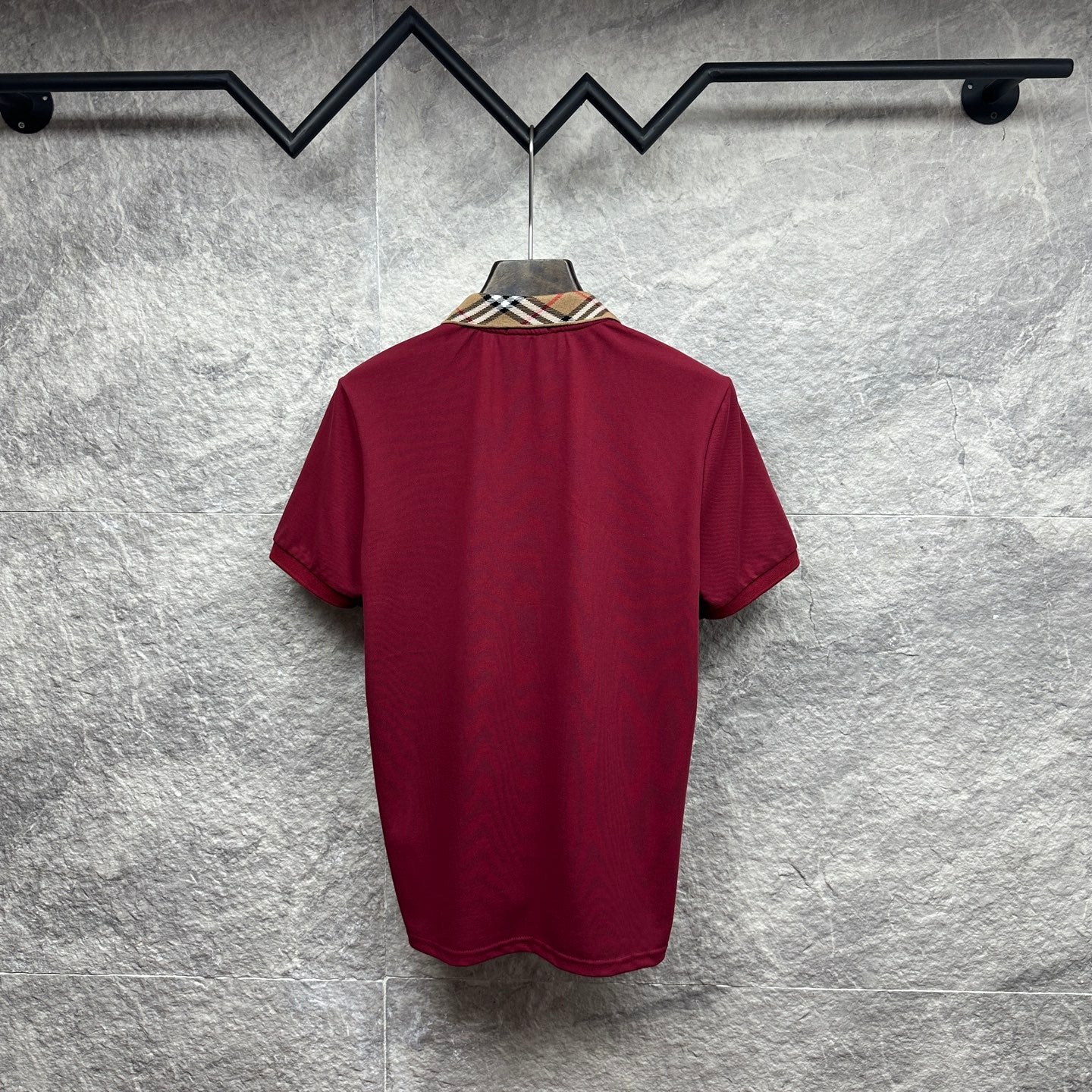 Maroon short-sleeve polo shirt, back view with check-pattern collar.