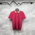 Maroon short-sleeve polo shirt with Burberry check collar and button placket.
