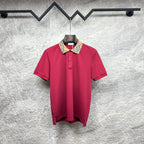 Maroon short-sleeve polo shirt with Burberry check collar and button placket.
