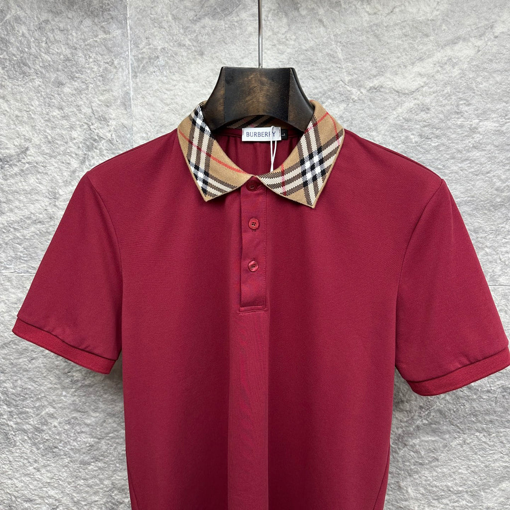 Maroon Burberry polo shirt with check collar, short sleeves, and button placket.