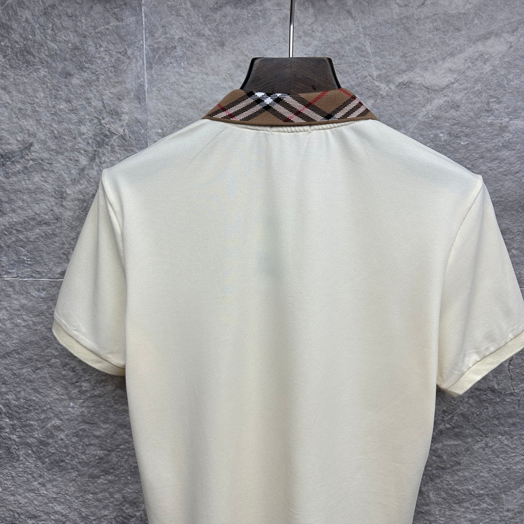 Cream polo shirt back with check-trim collar, hanging