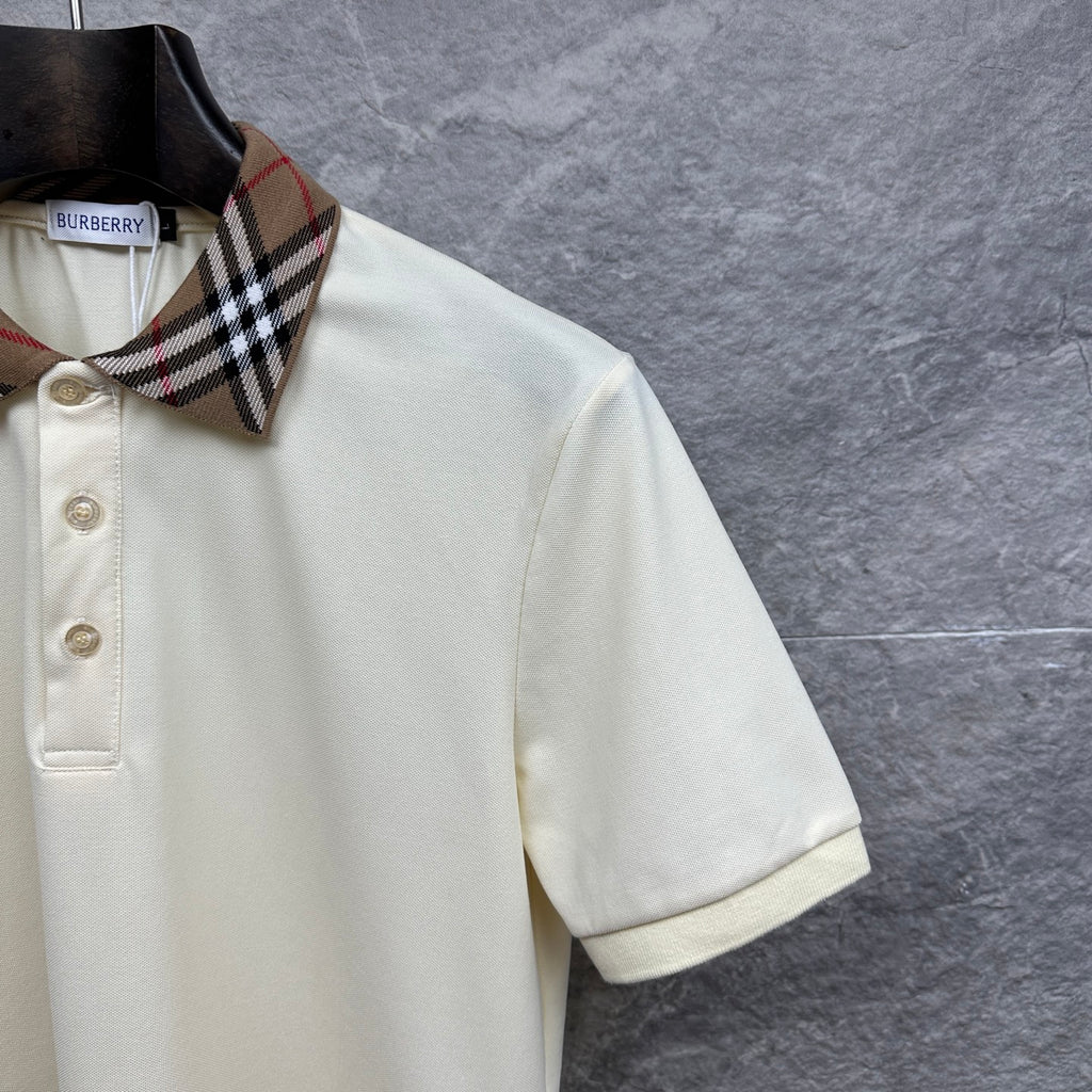 Cream polo shirt with short sleeves and check-collar trim, angled view
