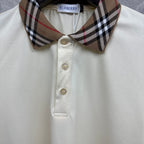 Cream polo shirt close-up of check collar and three button placket