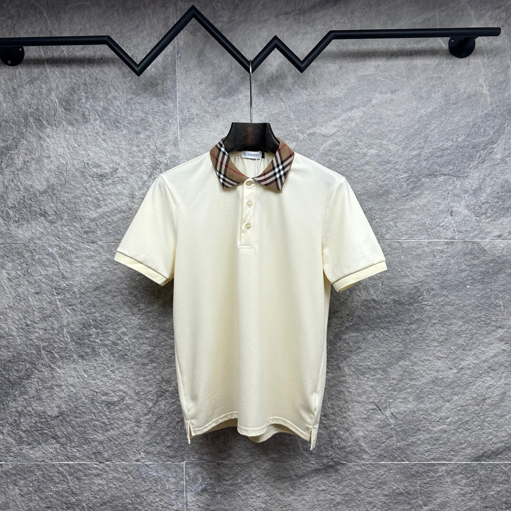 Cream polo shirt with check collar and button placket on a hanger