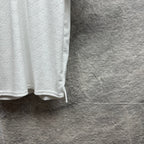 Gucci white polo shirt with embossed GG pattern and curved side hem.