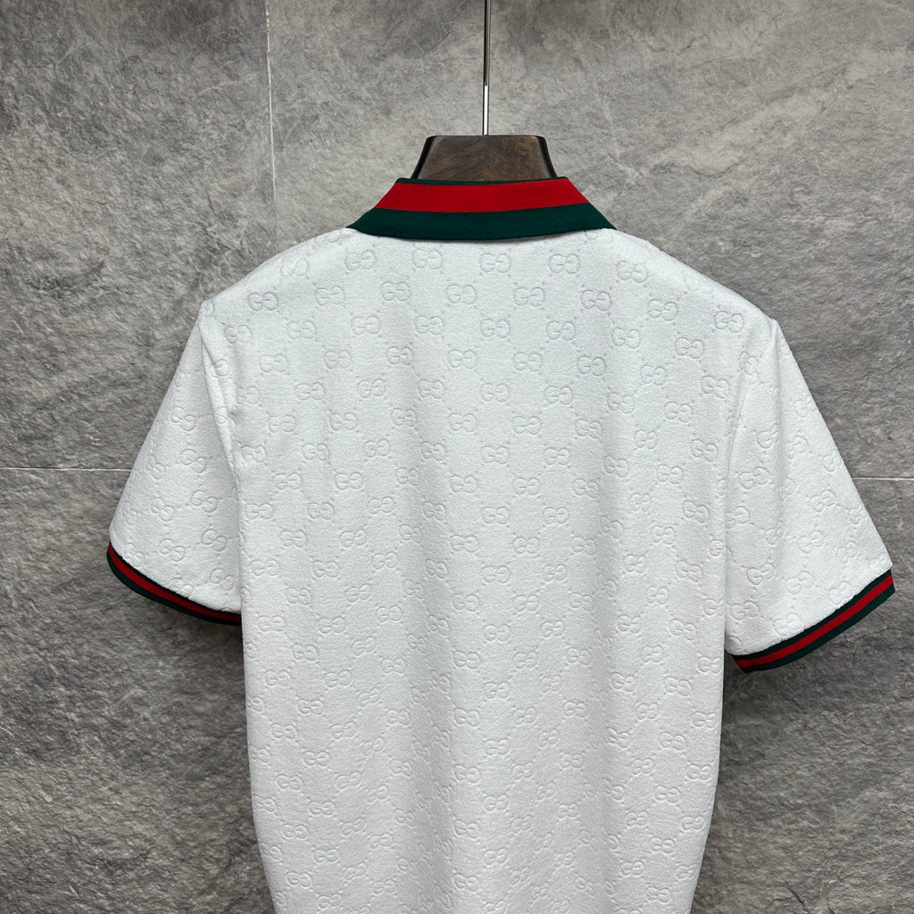 Gucci white polo shirt back view with embossed GG pattern and striped trim.