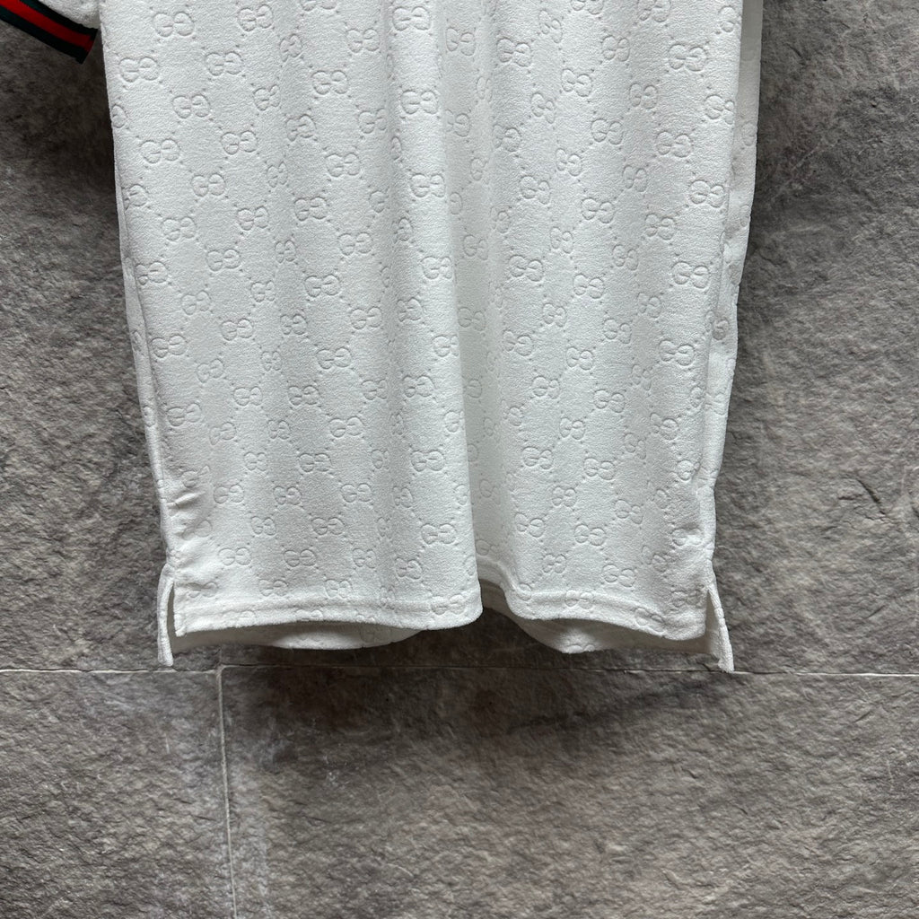 Gucci white polo shirt with embossed GG pattern and straight hem.
