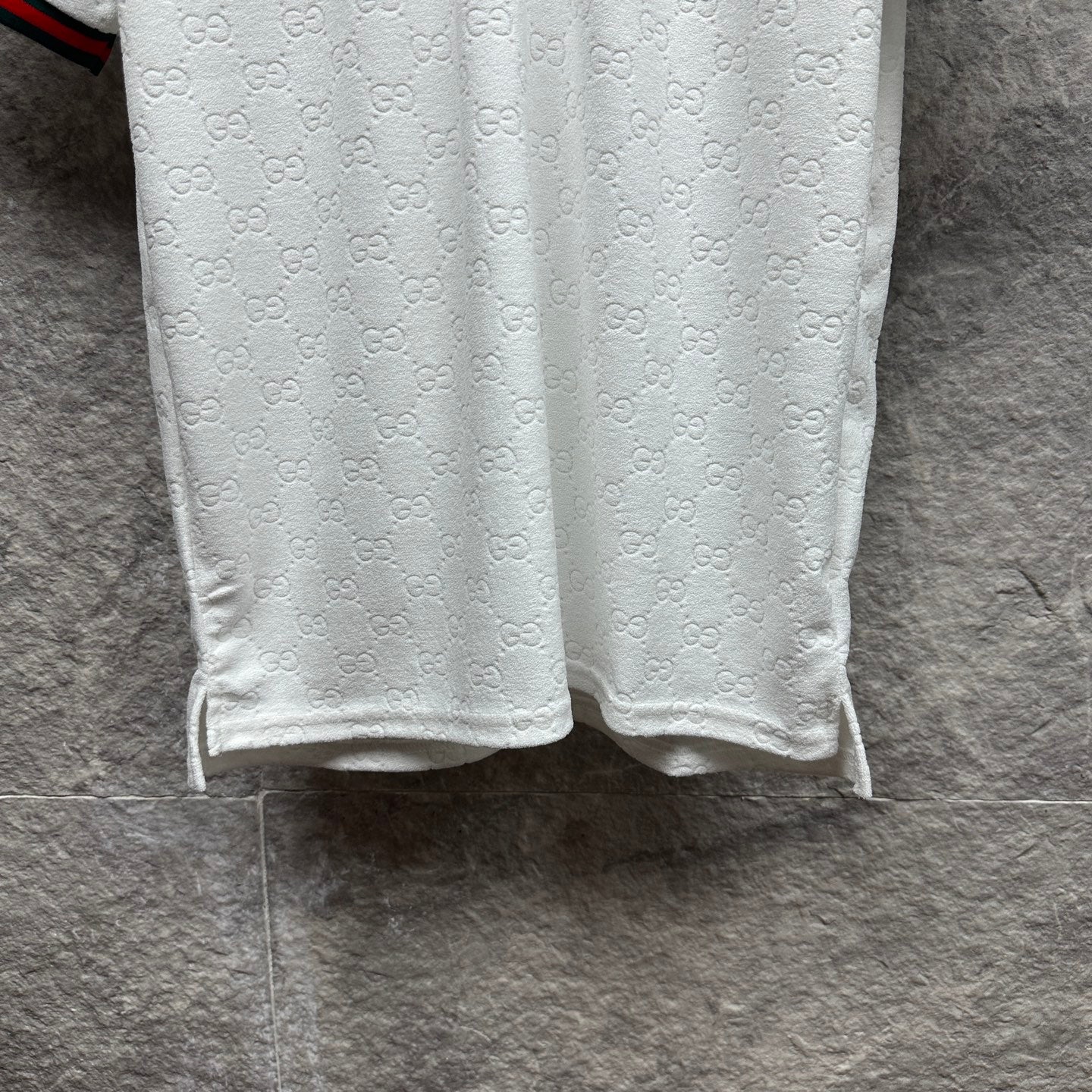Gucci white polo shirt with embossed GG pattern and straight hem.