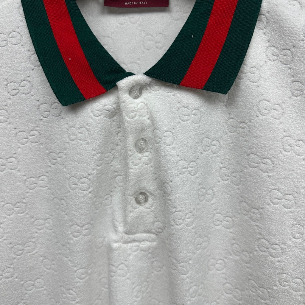 Gucci white polo shirt close-up with green-red striped collar and button placket.