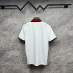 Gucci white polo shirt with green and red striped sleeve cuffs and collar.