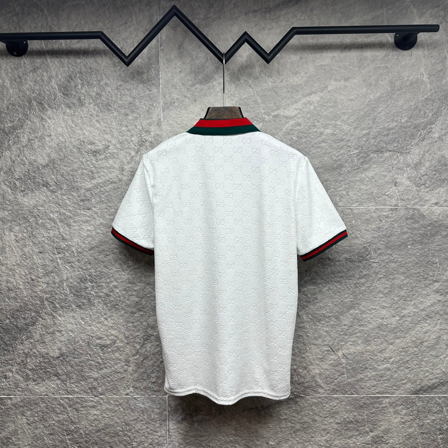 Gucci white polo shirt with green and red striped sleeve cuffs and collar.