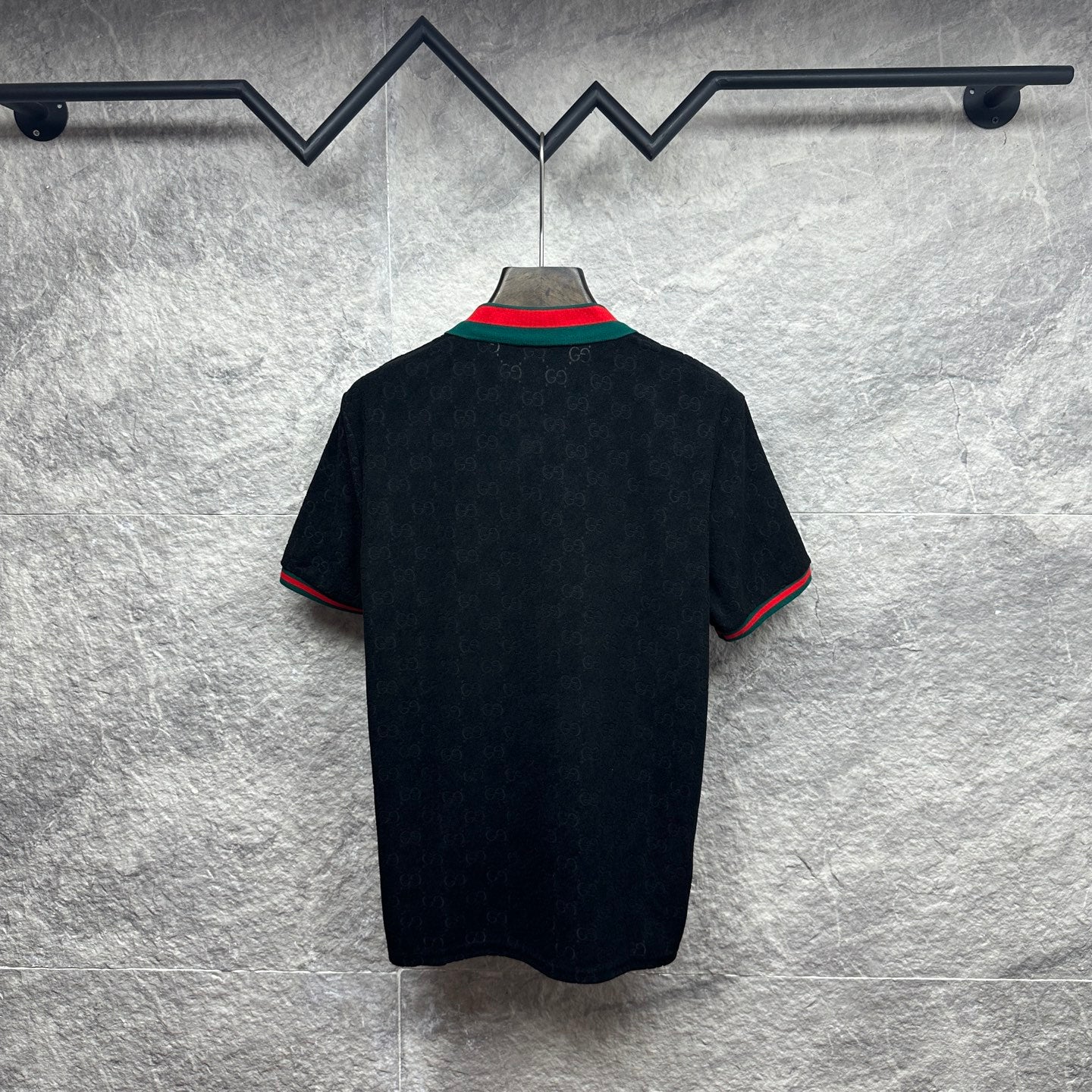 Gucci dark polo shirt, back view, with green-red striped sleeve and collar trim