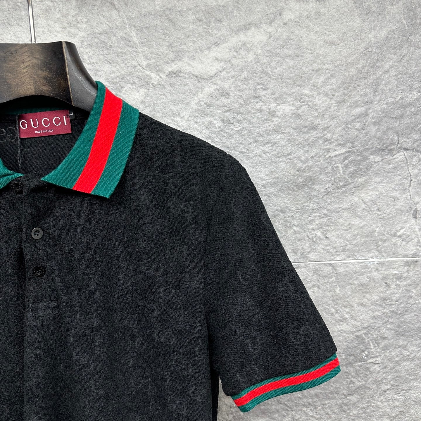 Gucci dark polo shirt close-up of striped collar and sleeve cuff trim