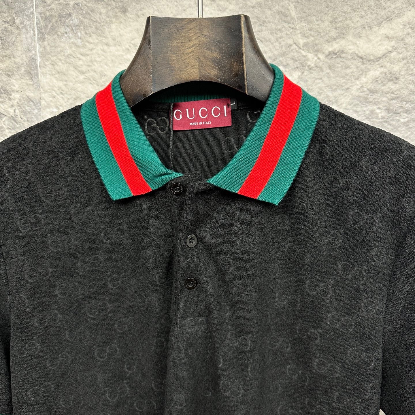 Gucci dark polo shirt close-up of striped collar and GUCCI label