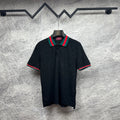 Gucci dark polo shirt with green-red striped collar and matching sleeve trim