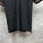Gucci dark polo shirt with subtle monogram pattern, short sleeves