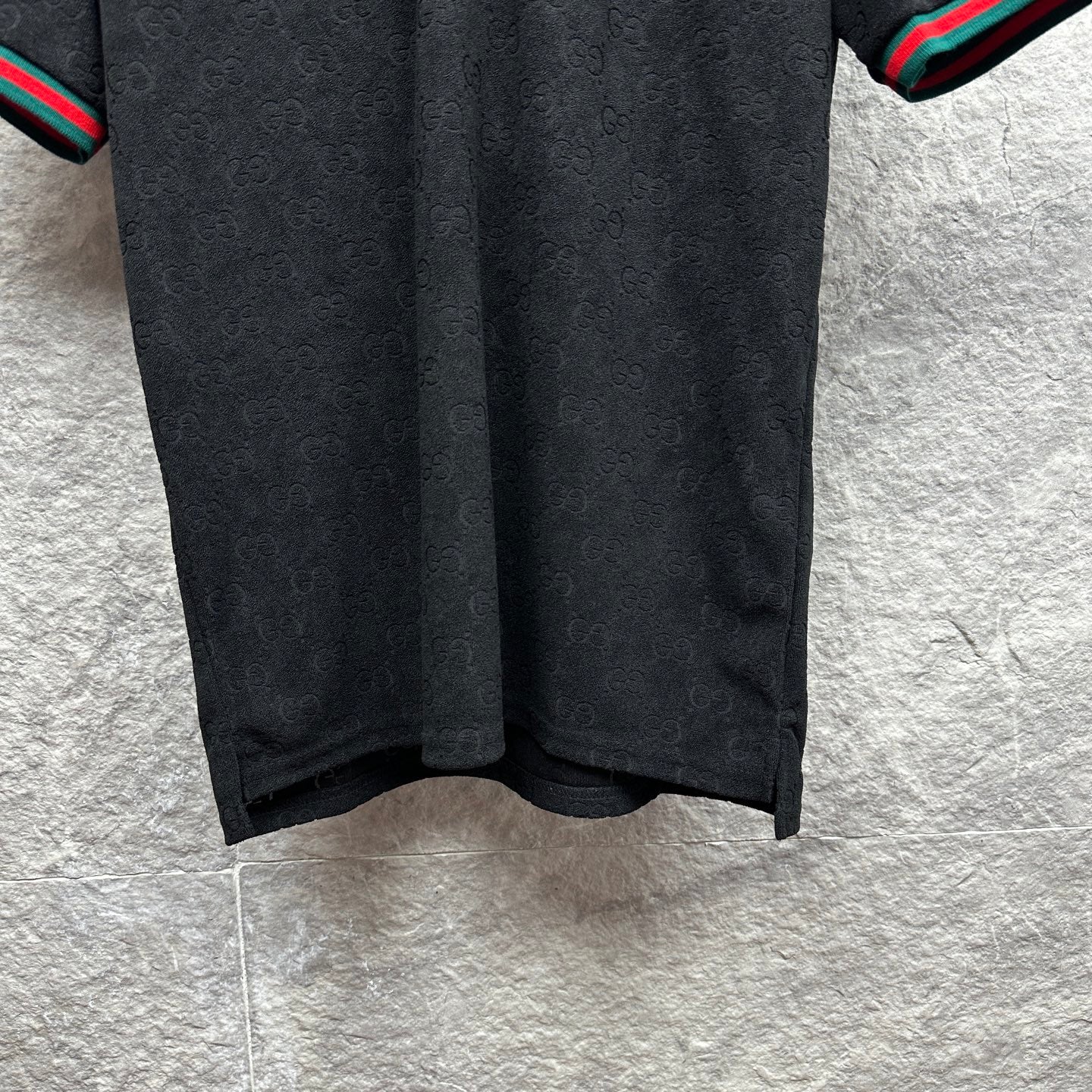 Gucci dark polo shirt with subtle monogram pattern, short sleeves