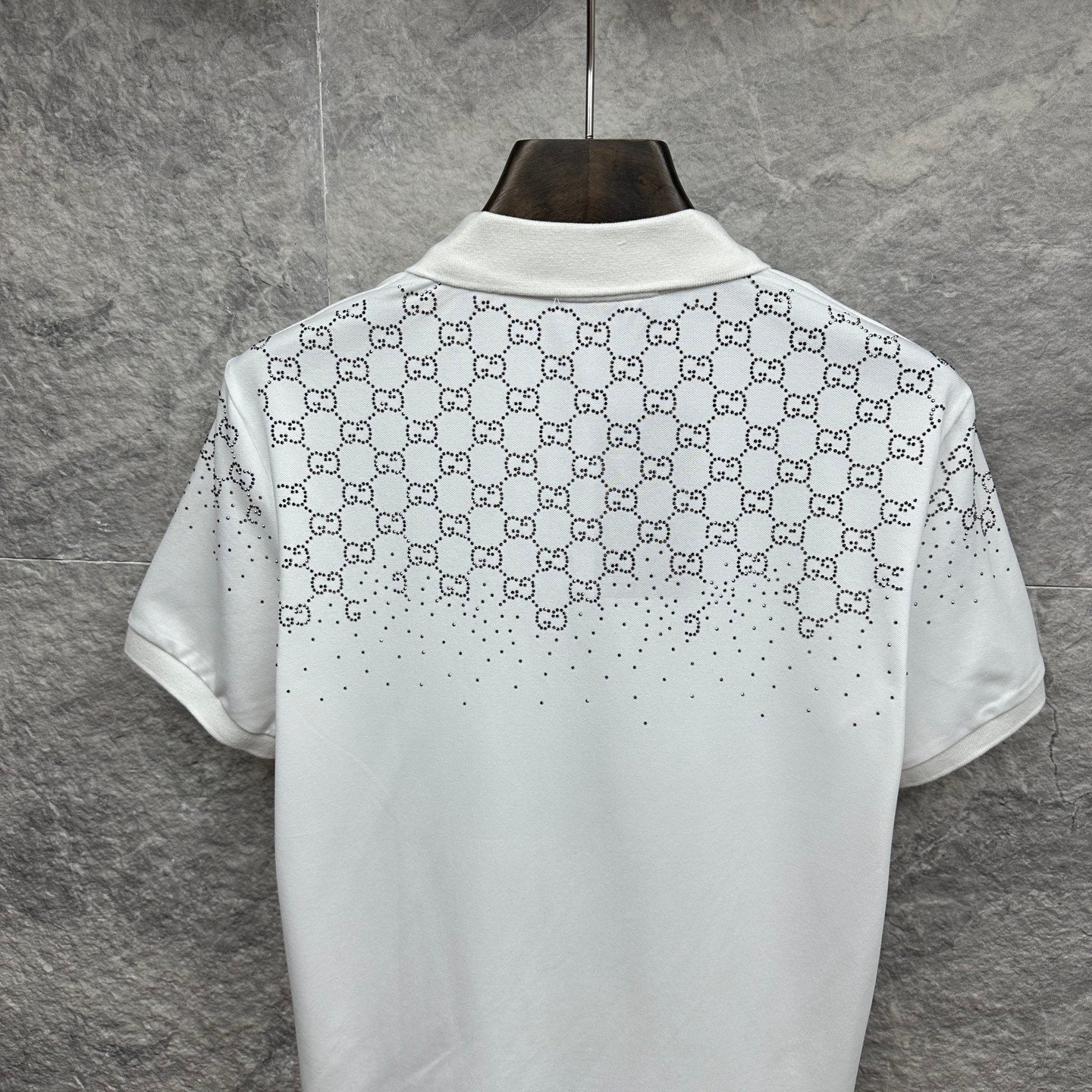 Gucci white polo shirt back view with GG logo pattern and stud accents