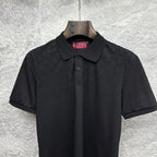 Black Gucci polo shirt with dark buttons and embroidered GG pattern