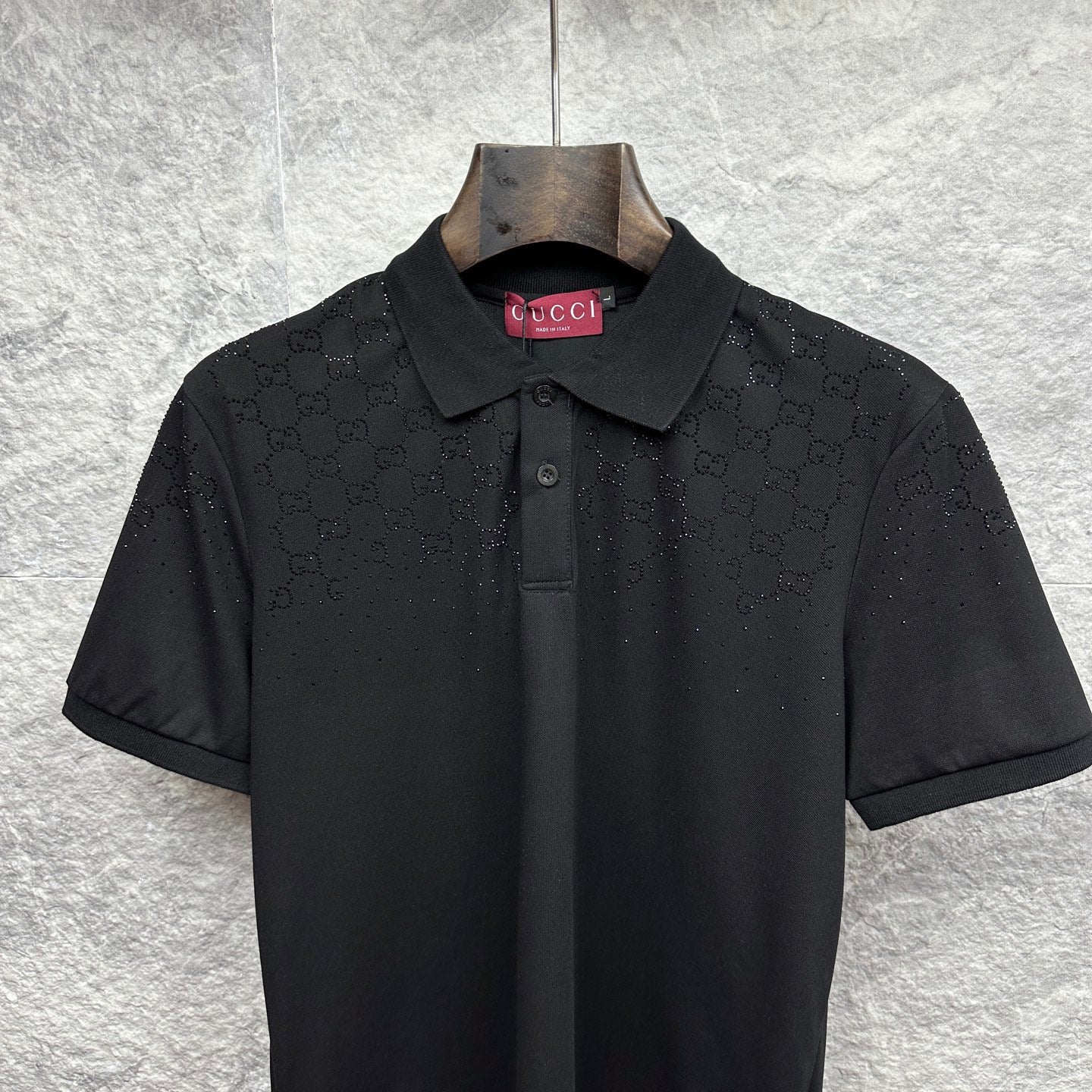 Black Gucci polo shirt with dark buttons and embroidered GG pattern