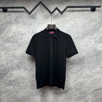 Black Gucci polo shirt with button placket and subtle GG pattern