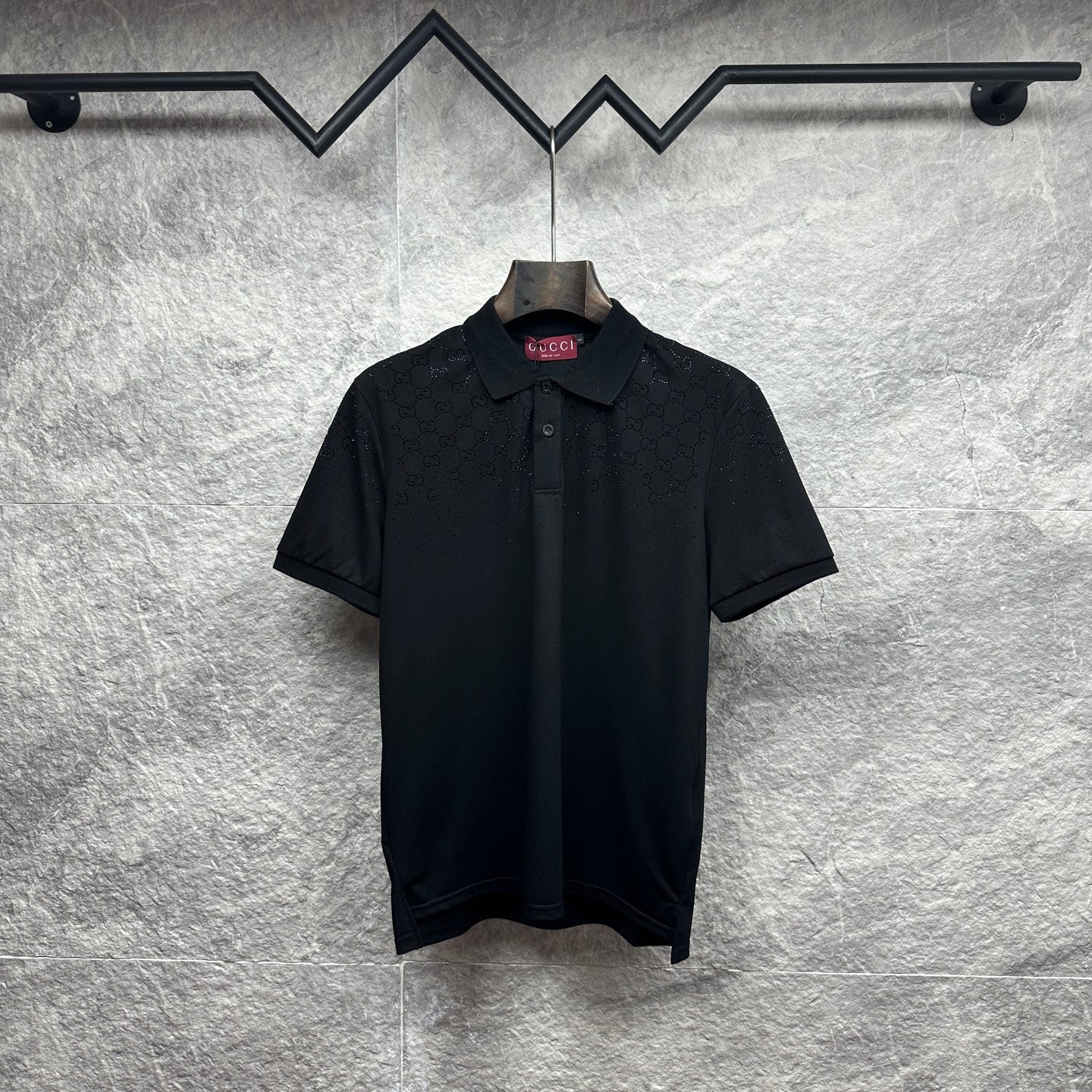 Black Gucci polo shirt with button placket and subtle GG pattern