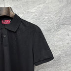 Black Gucci polo shirt sleeve with GG pattern and textured dots