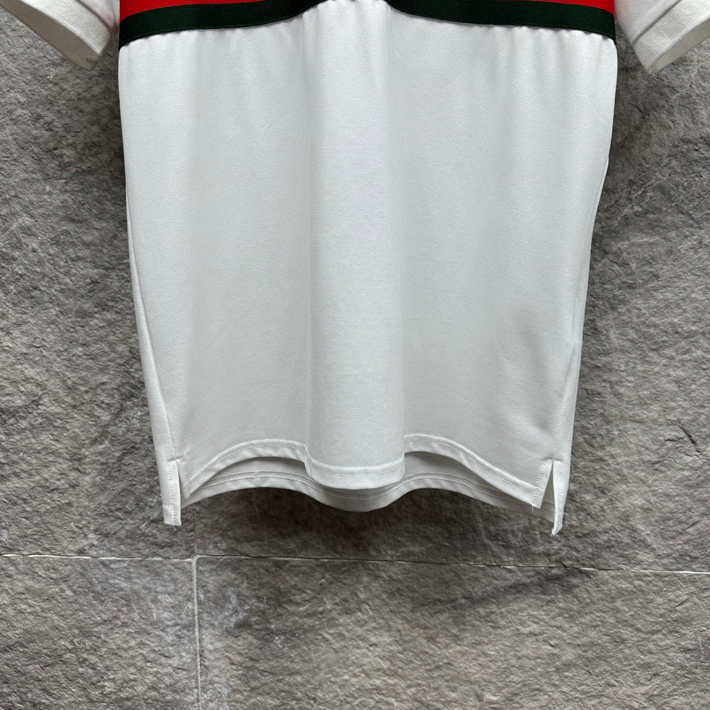 Gucci polo shirt in white with hem side slits and red and green striped band at waist