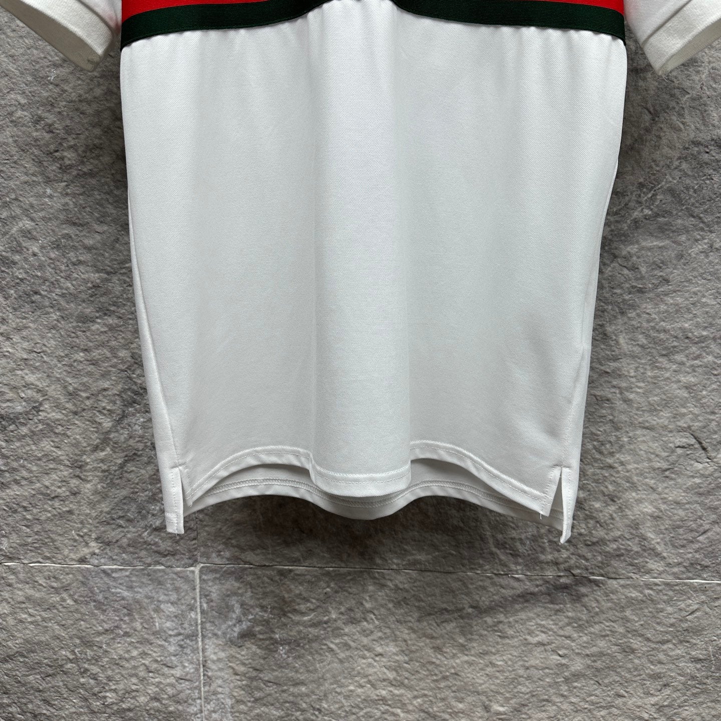 Gucci polo shirt in white with hem side slits and red and green striped band at waist