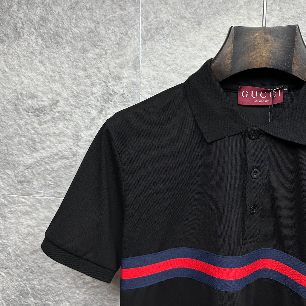 Black Gucci polo shirt close-up of collar and striped chest band.