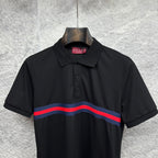 Black Gucci polo with buttoned placket and blue-red striped chest band.