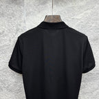 Black Gucci polo shirt back view with short sleeves on hanger.