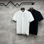 White and black Gucci polo shirts on hangers, short sleeves