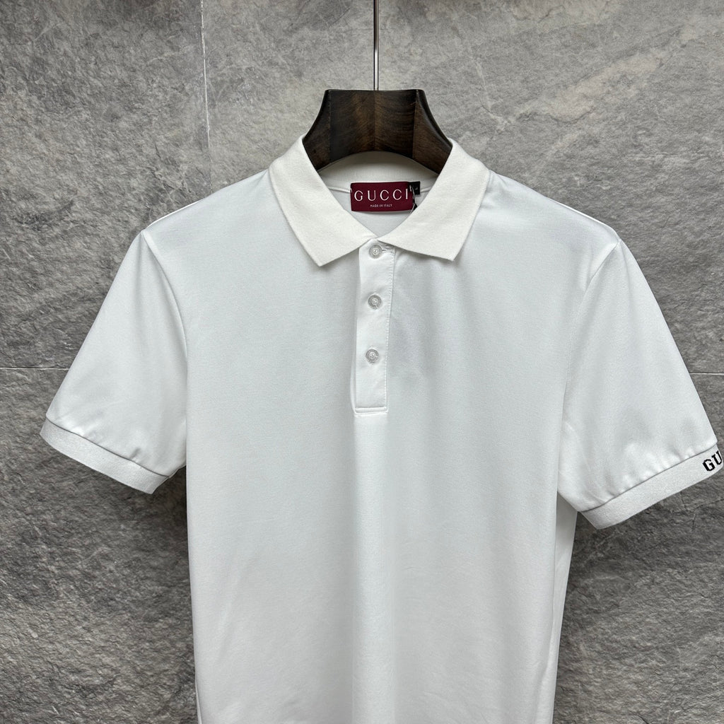 White Gucci polo shirt with pointed collar, button placket, and GUCCI neck label
